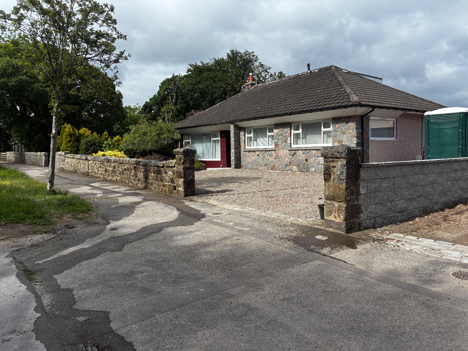 New Fyfe stone boundary wall with stone pillars and gravel driveway on Springfield Road, Aberdeen